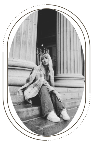 a picture of Ida Toldnæs sitting on some stairs in black and white